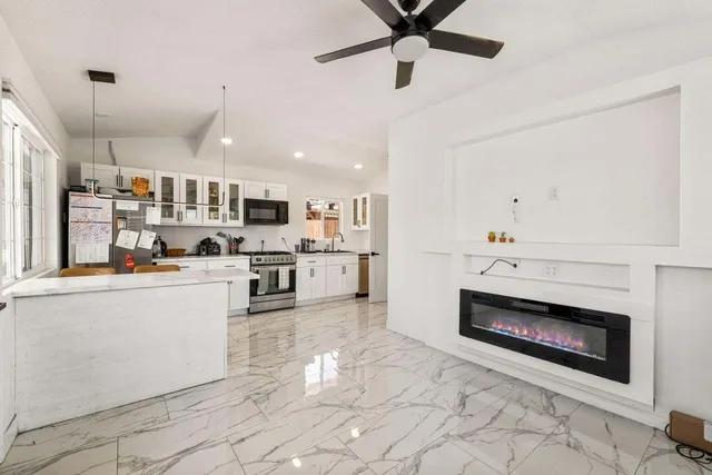 a open kitchen with cabinets and stainless steel appliances