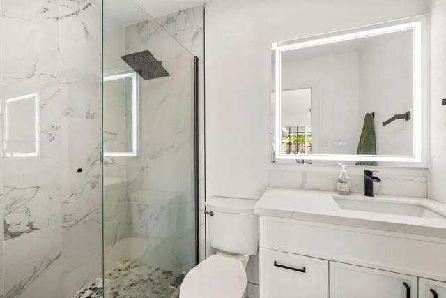 a bathroom with a sink toilet and shower