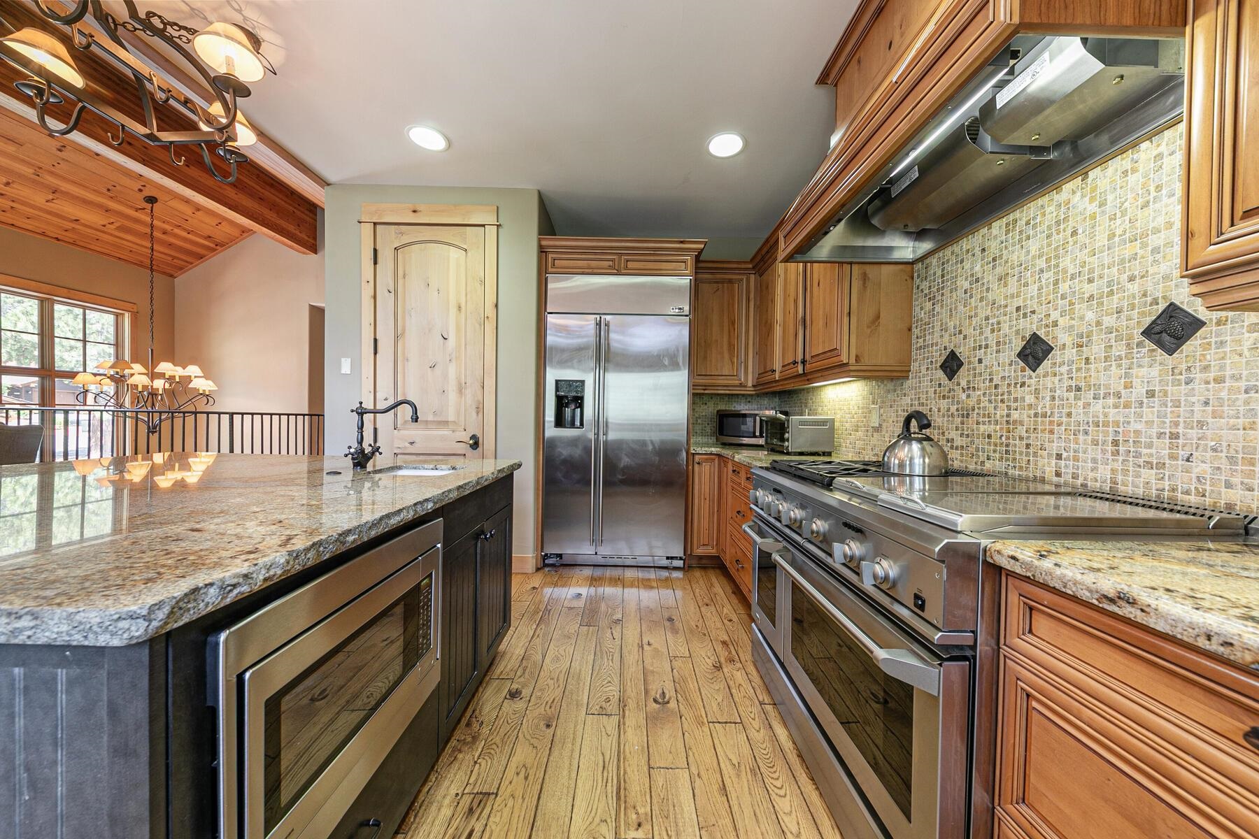 10243 Valmont Trail Truckee, CA 96161 - Photo 12 of 28 a kitchen with stainless steel appliances granite countertop a stove a sink and a refrigerator