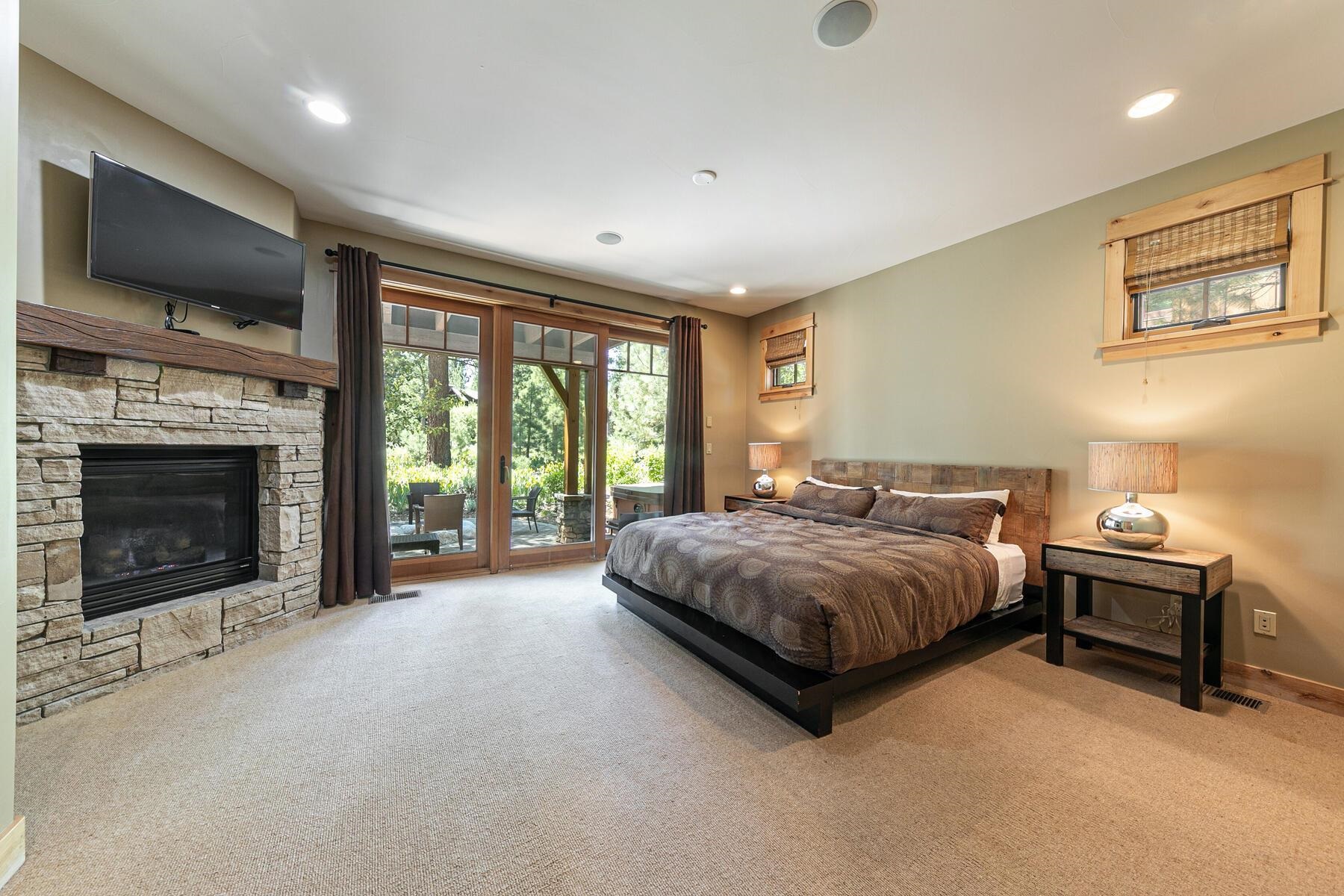 10243 Valmont Trail Truckee, CA 96161 - Photo 13 of 28 a spacious bedroom with a bed and a fireplace