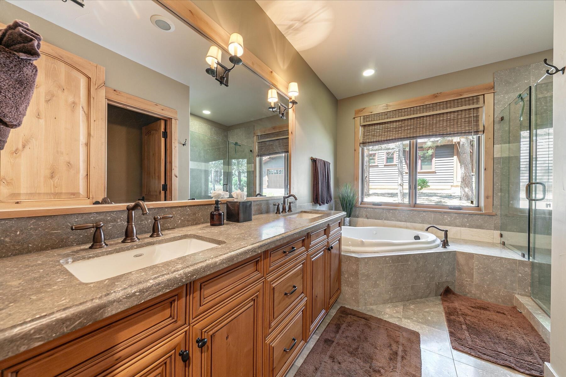 10243 Valmont Trail Truckee, CA 96161 - Photo 14 of 28 a bathroom with a granite countertop sink and a large mirror
