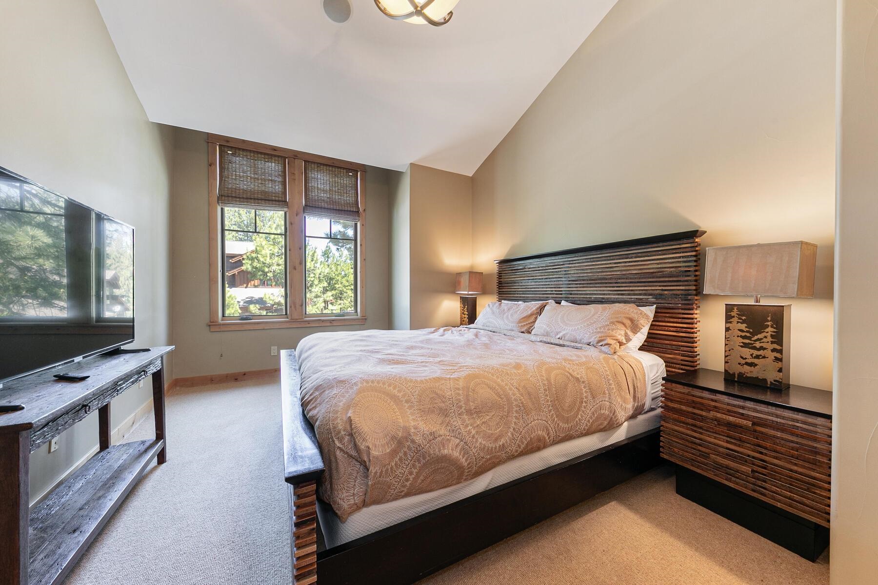 10243 Valmont Trail Truckee, CA 96161 - Photo 17 of 28 a bedroom with a bed and a flat screen tv