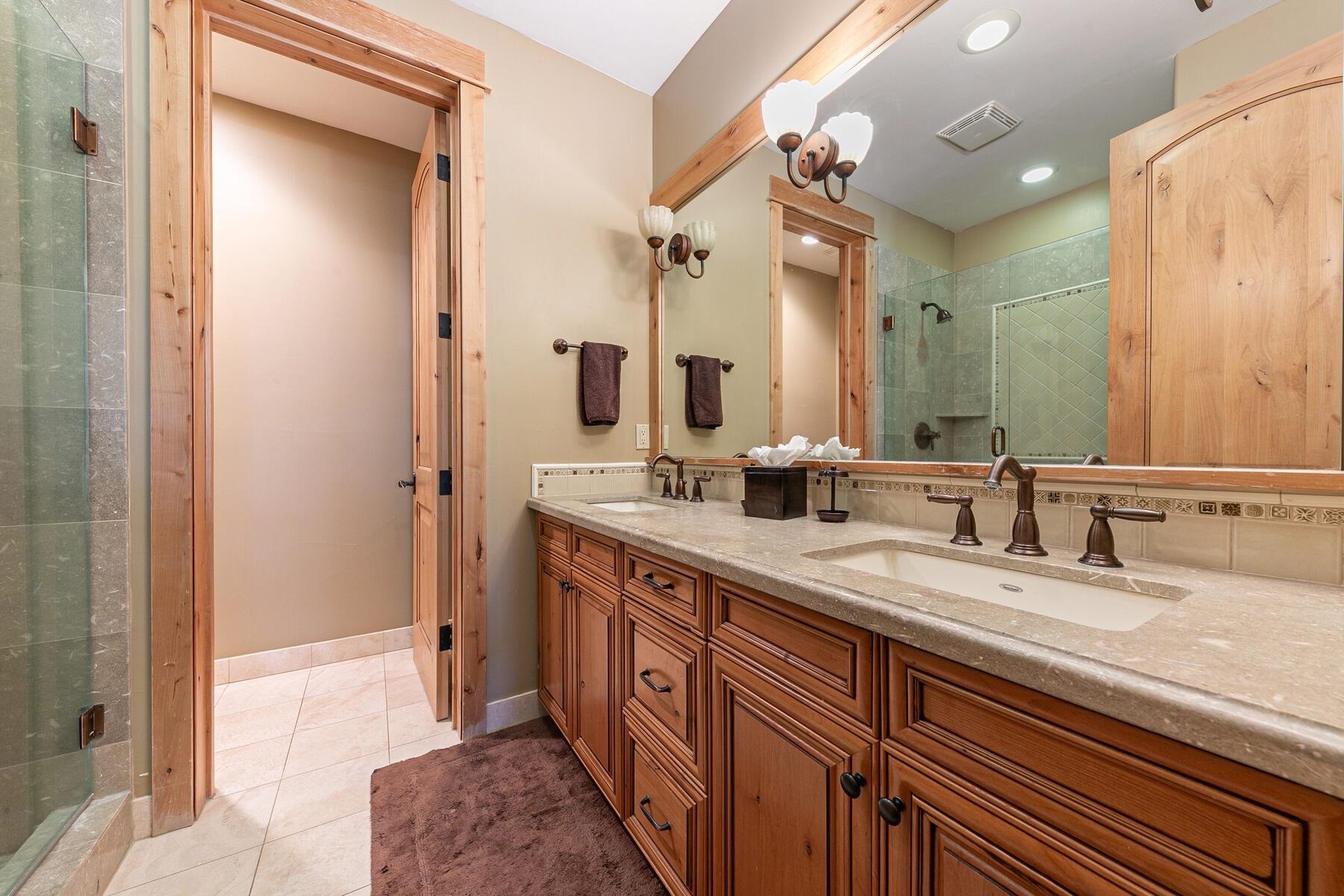 10243 Valmont Trail Truckee, CA 96161 - Photo 18 of 28 a spacious bathroom with a double vanity sink a mirror and a shower