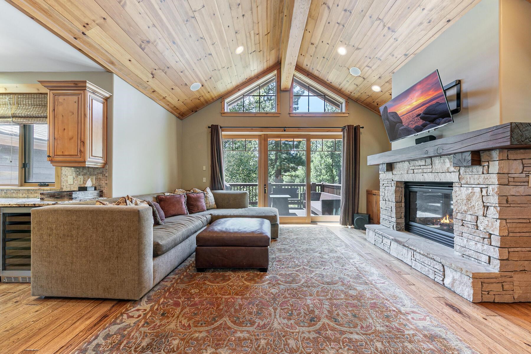 10243 Valmont Trail Truckee, CA 96161 - Photo 6 of 28 a living room with furniture a fireplace and a large window