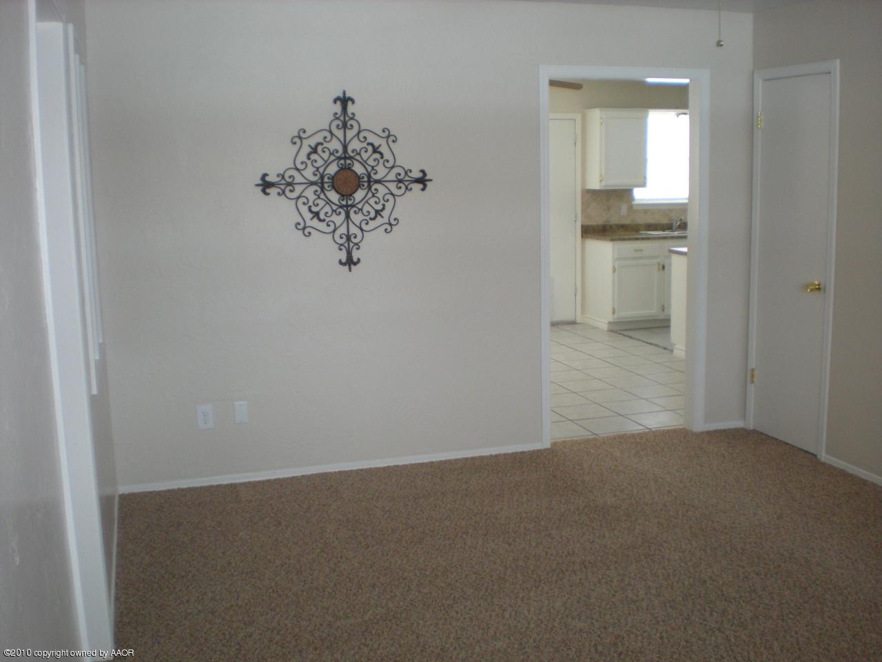 8119 Goodnight Trail Amarillo, TX 79110 - Photo 3 of 12 a view of a small space with wooden floor and a window