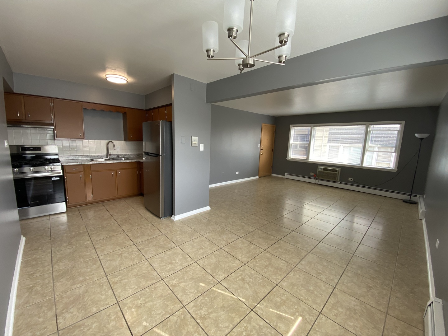 4345 West 63rd Street, Unit 2D Chicago, IL 60629 - Photo 6 of 12 a kitchen with stainless steel appliances granite countertop a stove a sink and a refrigerator