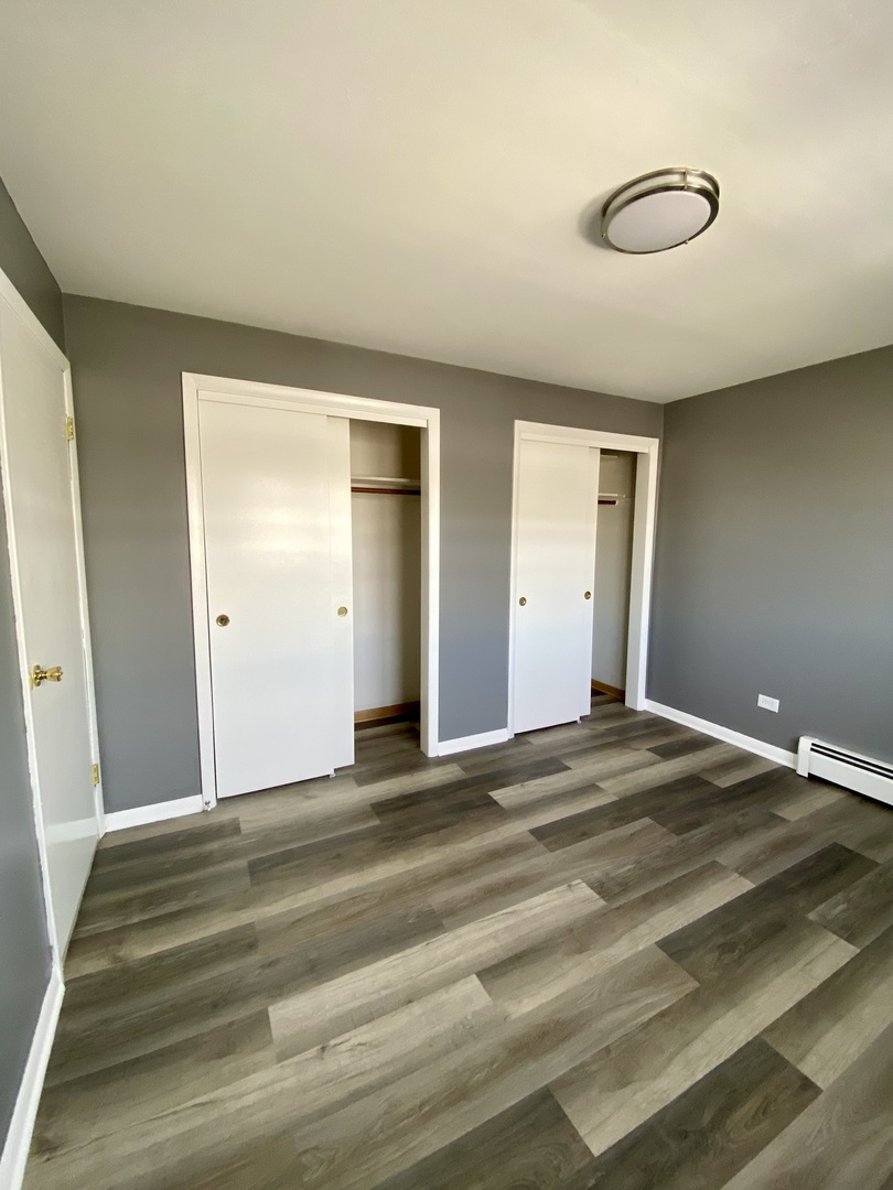 4345 West 63rd Street, Unit 2D Chicago, IL 60629 - Photo 8 of 12 a view of a livingroom with wooden floor and closet
