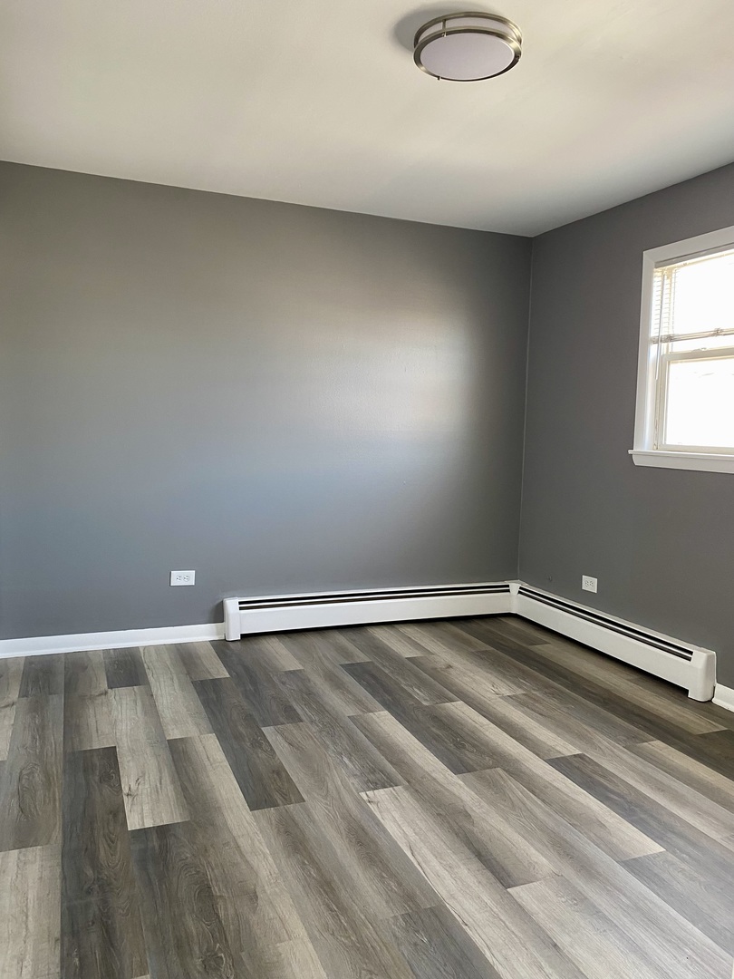 4345 West 63rd Street, Unit 2D Chicago, IL 60629 - Photo 9 of 12 a view of room with wooden floor