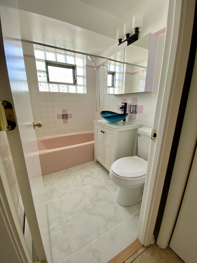 4345 West 63rd Street, Unit 2D Chicago, IL 60629 - Photo 10 of 12 a bathroom with a toilet a sink a tub and shower