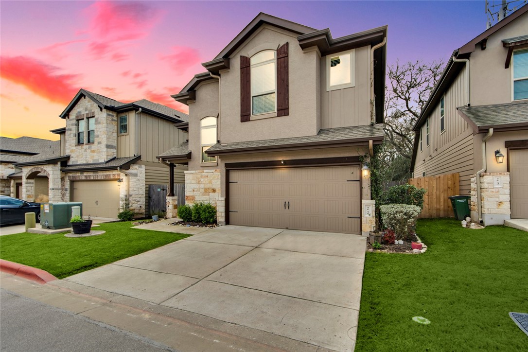 a front view of a house with a yard and garage