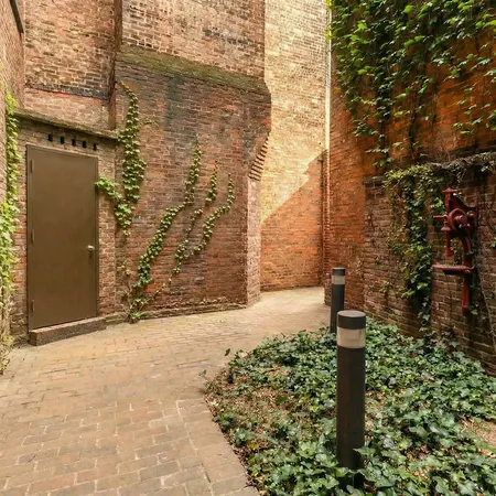 a bedroom with a large bed and a painting on the wall