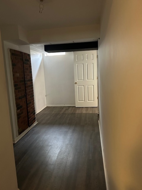 2093 Kettering Road Hoffman Estates, IL 60169 - Photo 23 of 28 an empty room with wooden floor and windows with curtains