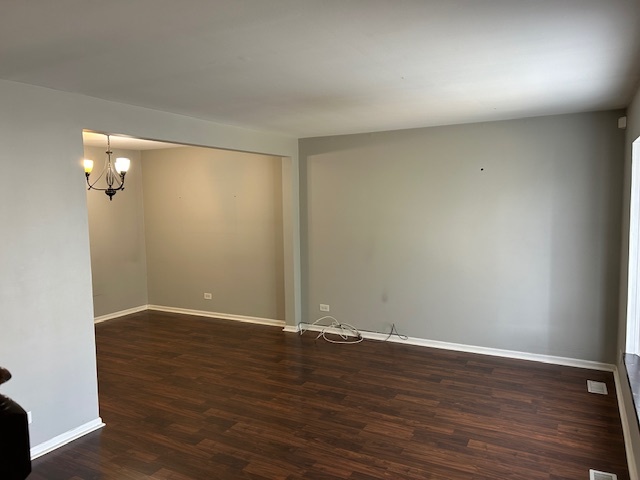2093 Kettering Road Hoffman Estates, IL 60169 - Photo 3 of 28 an empty room with wooden floor and windows