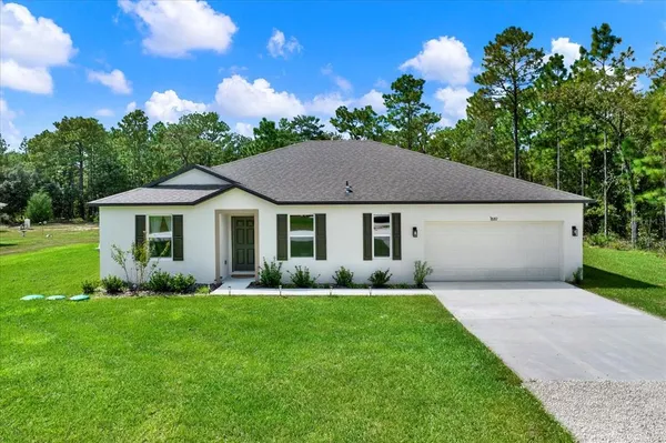 a aerial view of a house with garden and trees