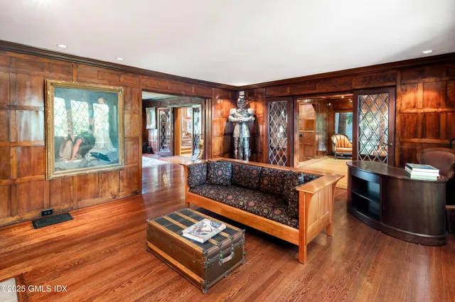 a living room with furniture kitchen view and a chandelier