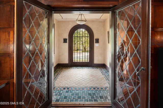 a living room with furniture fireplace and wooden floor