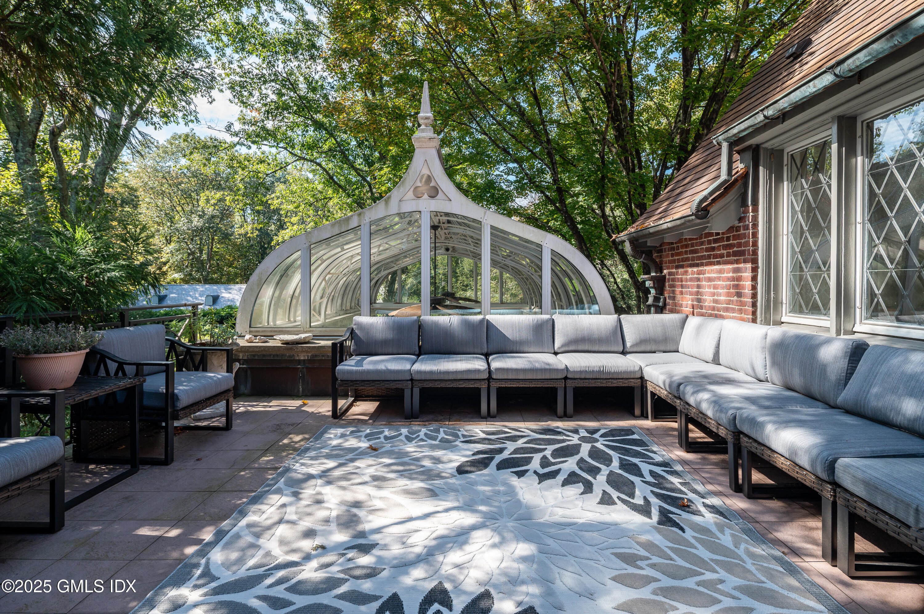 214 Good Hill Road Weston, CT 06883 - Photo 78 of 80 a backyard of a house with barbeque oven and outdoor seating