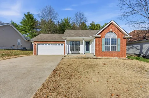 a front view of a house with yard and garage