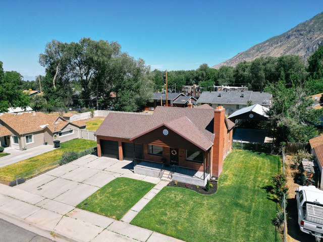 673 East 700 South Springville, UT 84663 - Photo 5 of 43 Brick and wood-sided residence featuring a two-car garage