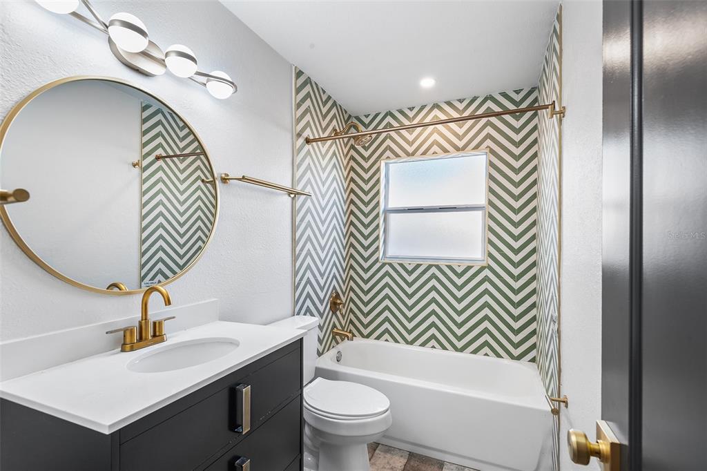 810 22nd Street North St. Petersburg, FL 33713 - Photo 20 of 37 a bathroom with a sink a toilet and a mirror