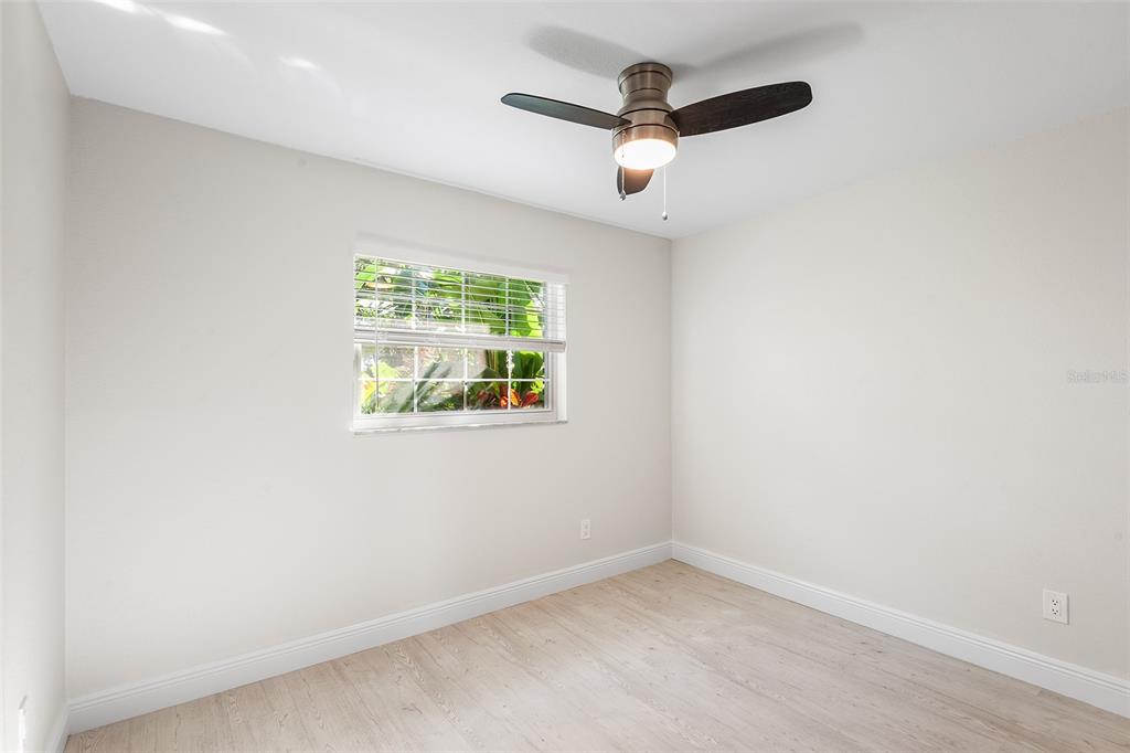 810 22nd Street North St. Petersburg, FL 33713 - Photo 21 of 37 an empty room with a window and a ceiling fan