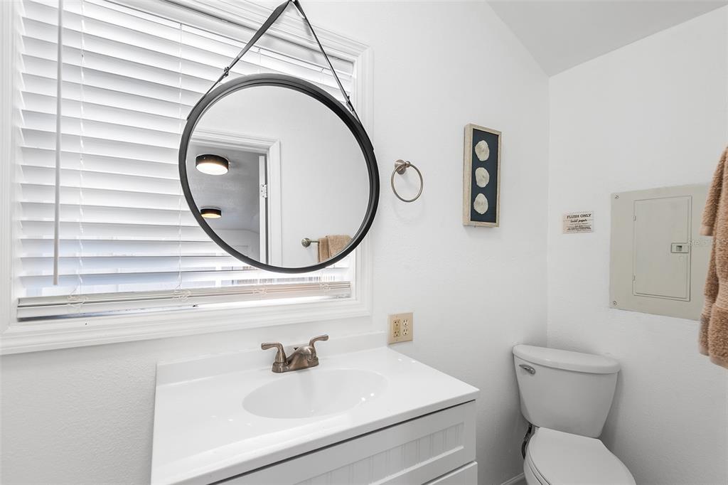 810 22nd Street North St. Petersburg, FL 33713 - Photo 29 of 37 a bathroom with a sink a toilet and a mirror