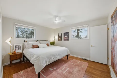 a bedroom with a bed and a painting on the wall