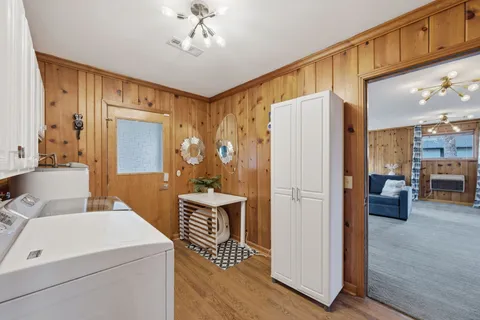 a room with furniture a ceiling fan and a view of kitchen