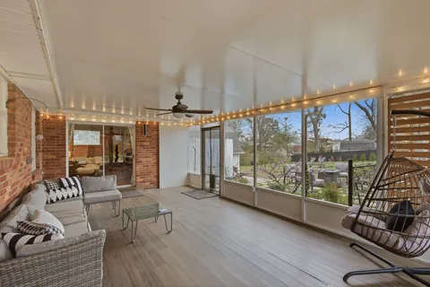 a living room with furniture and a floor to ceiling window