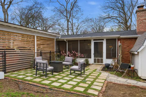 a view of a house with backyard sitting area and porch