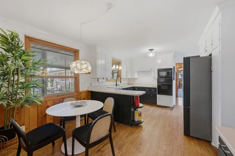 a kitchen with a table and chairs in it