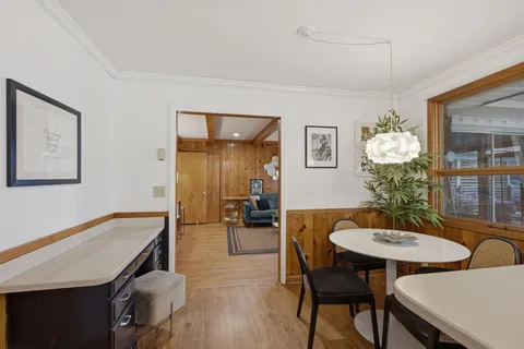 a view of a dining room with furniture and wooden floor