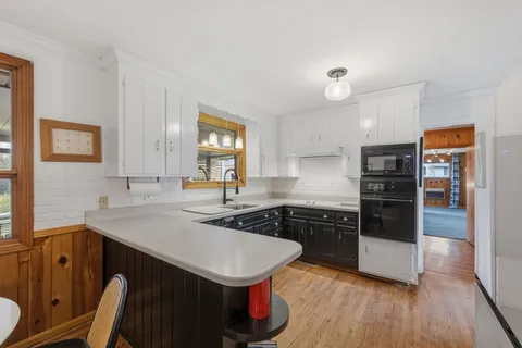a kitchen with a sink a stove and refrigerator