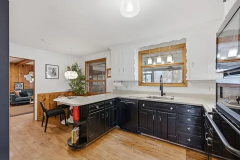a kitchen with a sink stove and cabinets