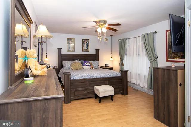 a bedroom with a bed and flat screen tv