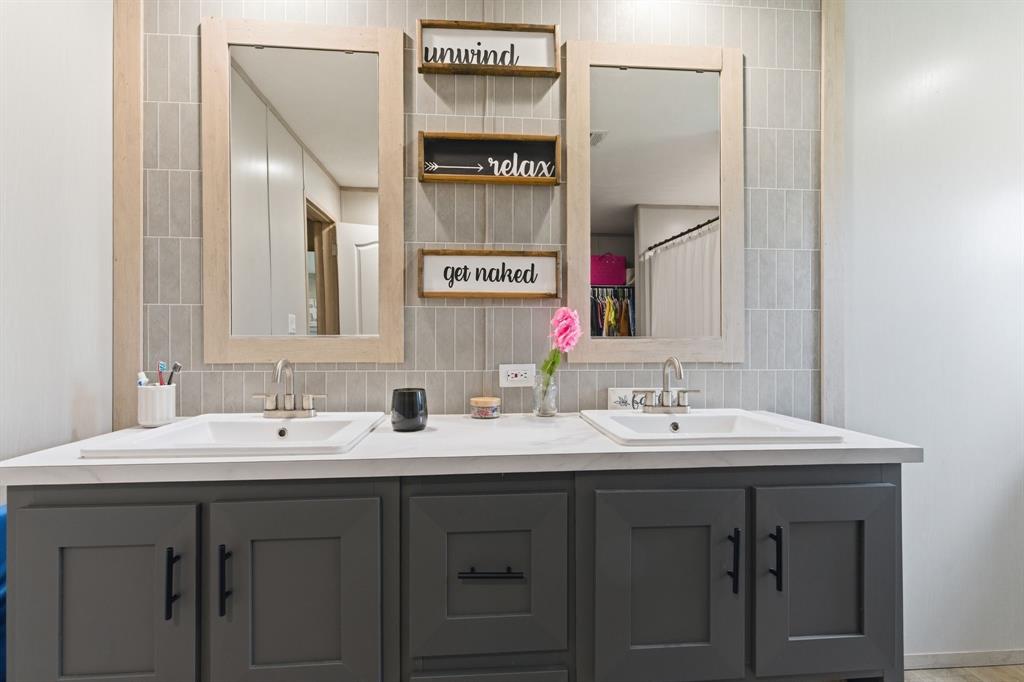 8792 Highway 67 Saltillo, TX 75478 - Photo 25 of 40 a bathroom with a double vanity sink and a mirror