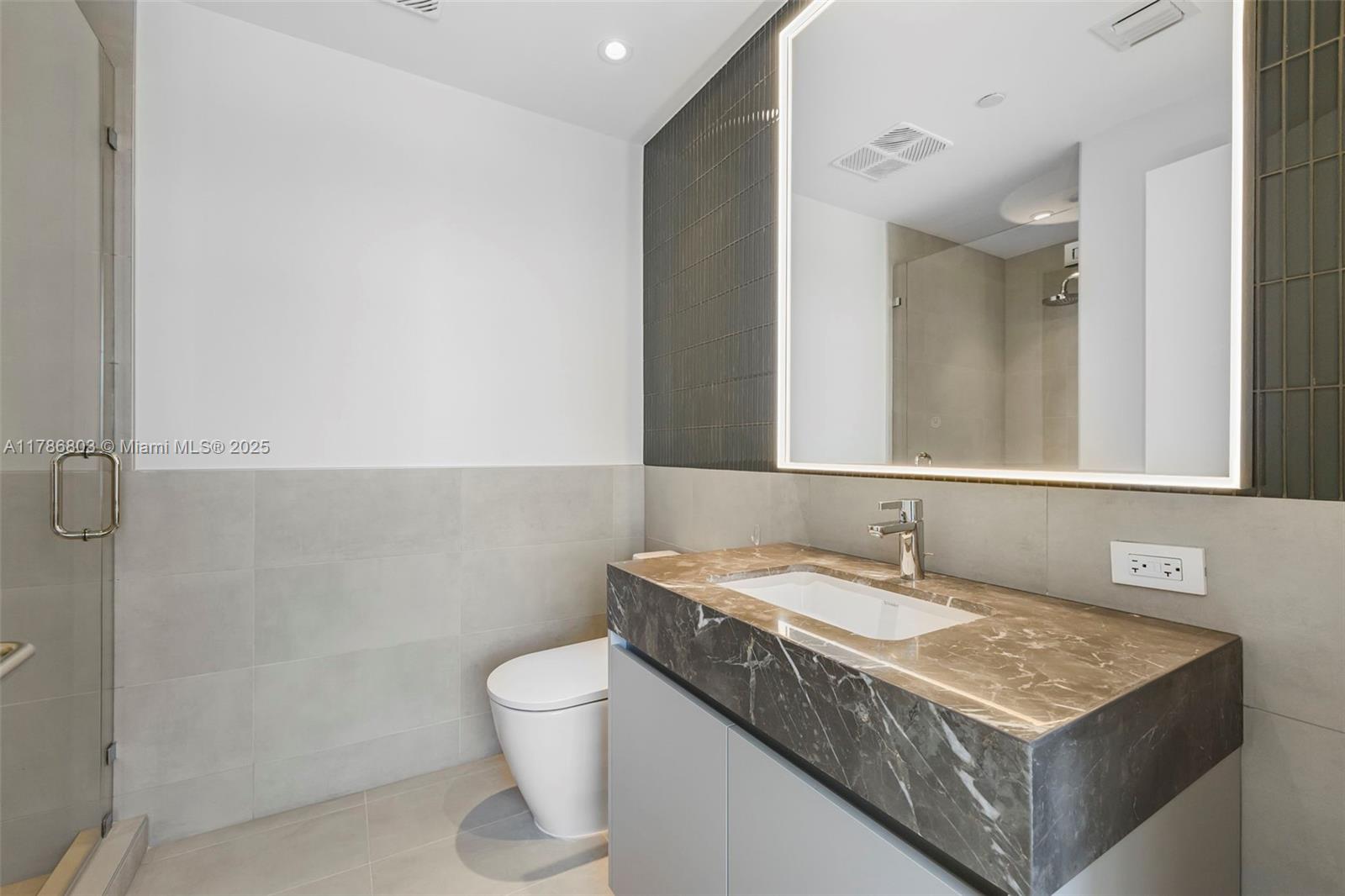 500 Alton Road, Unit 902 Miami Beach, FL 33139 - Photo 10 of 15 a bathroom with a granite countertop sink a toilet and a mirror