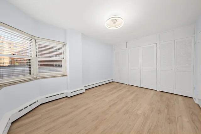 a view of a room with wooden floor and window