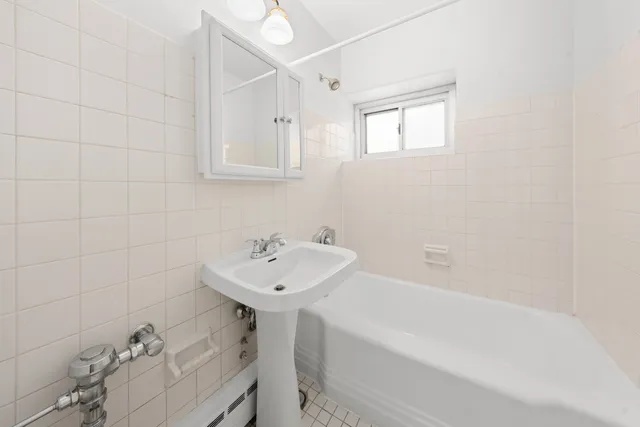 a bathroom with a sink a toilet and bathtub