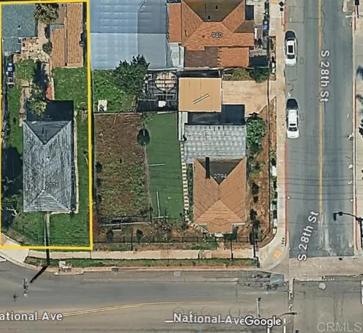 an aerial view of a residential houses with outdoor space and street view