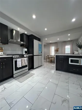 a kitchen with stainless steel appliances granite countertop a refrigerator and a sink