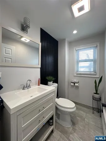 a bedroom with a bed and a large mirror