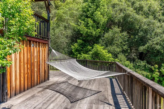 a view of balcony with wooden floor and fence