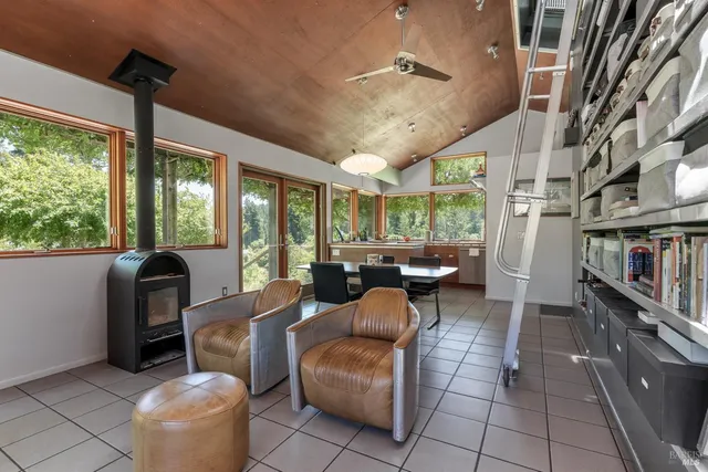 a living room with furniture and a floor to ceiling window