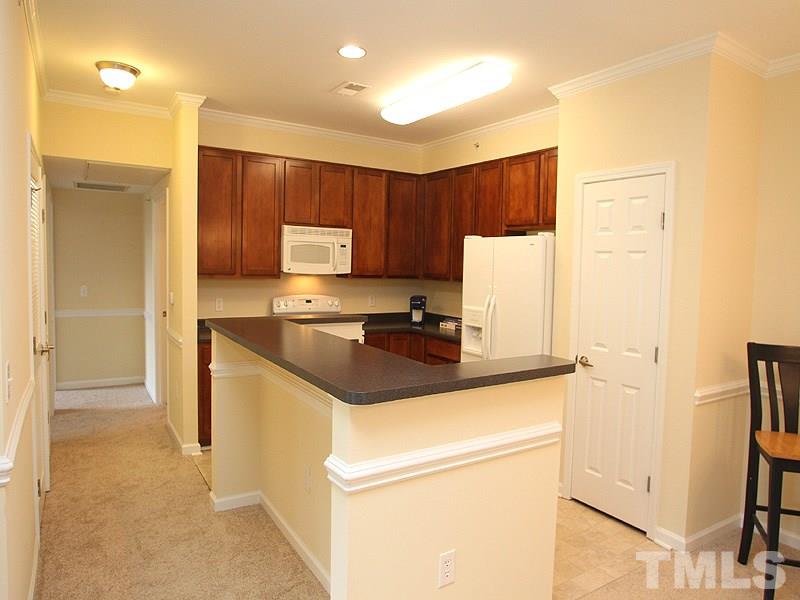 534 Weather Ridge Lane, Unit 18 Cary, NC 27513 - Photo 9 of 21 The bright kitchen has plenty of counter space, 42" cabinets, great appliances and a pantry. The counter island features space for seated eating or snacking.