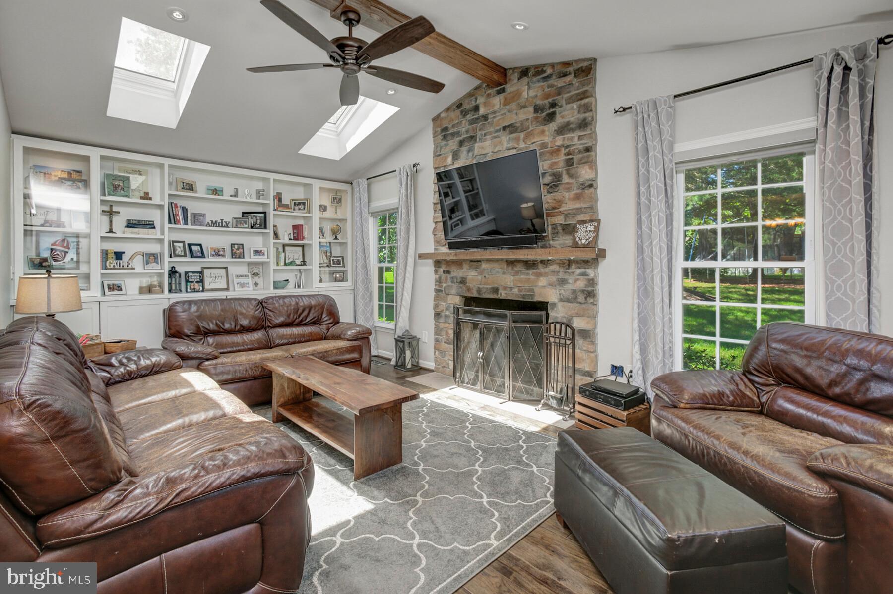 307 Saddle Ridge Road Annapolis, MD 21403 - Photo 16 of 46 a living room with furniture a flat screen tv and a fireplace