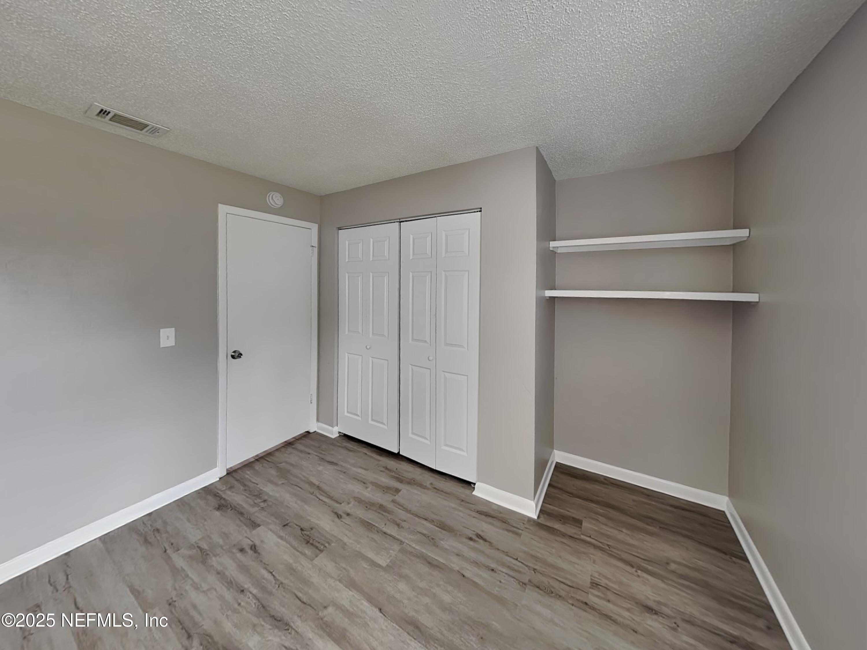 31 Folson Lane Palm Coast, FL 32137 - Photo 11 of 15 a view of an empty room with wooden floor