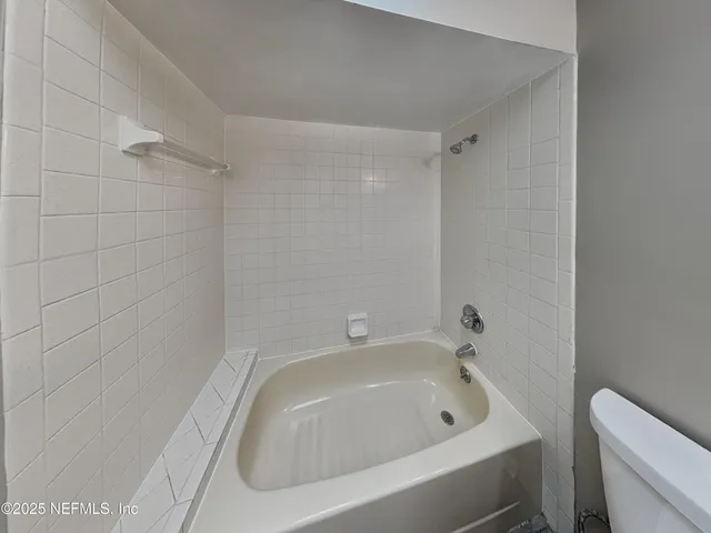 a bathroom with a tub and sink