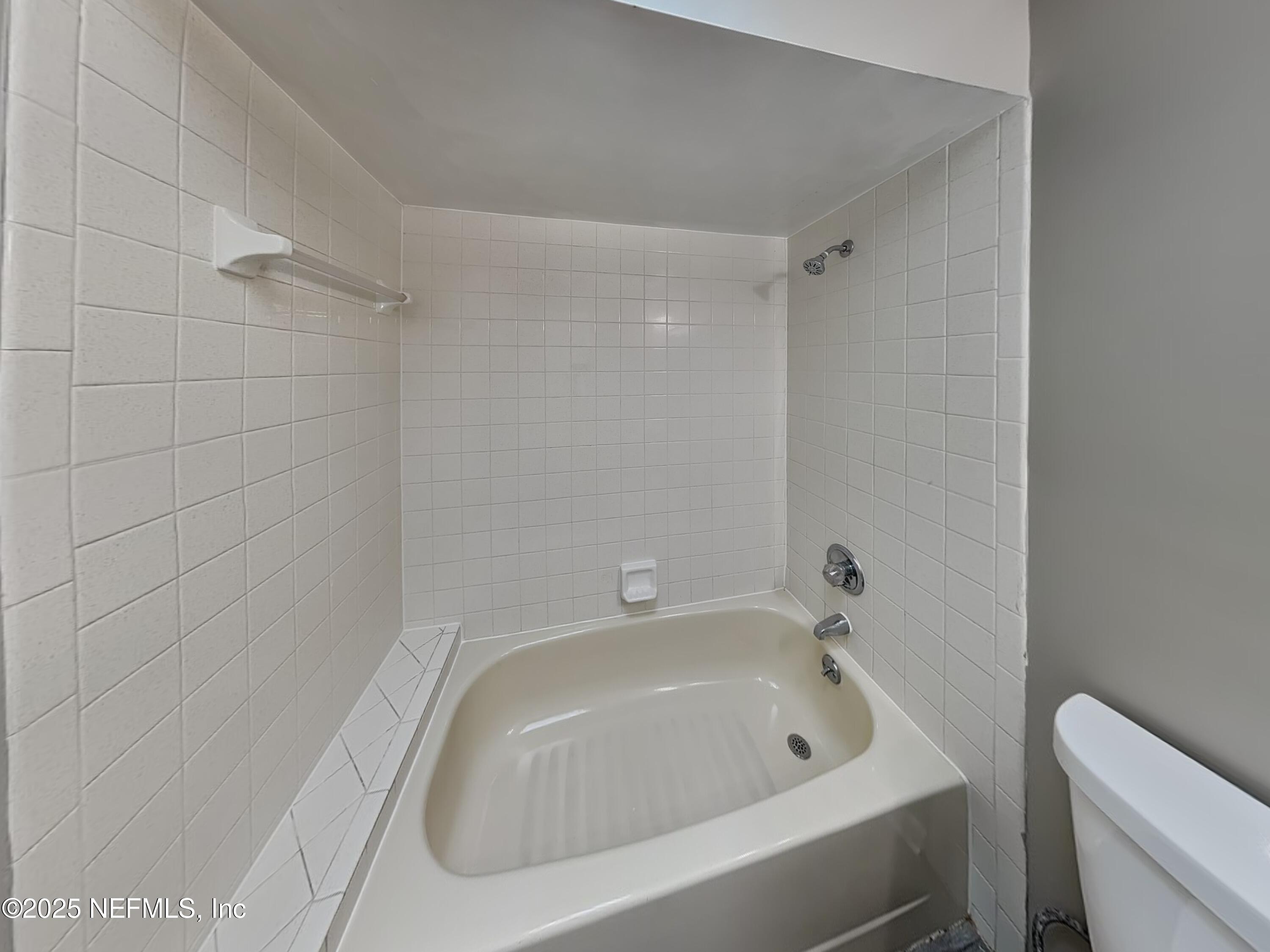 31 Folson Lane Palm Coast, FL 32137 - Photo 13 of 15 a bathroom with a tub and sink