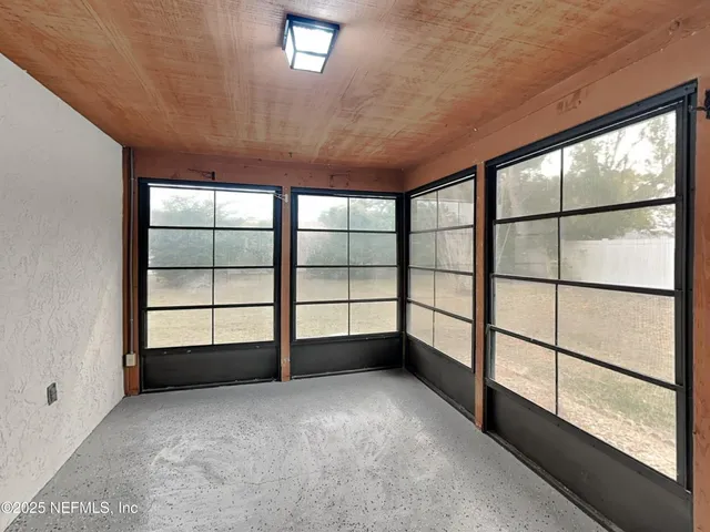 a view of empty room with windows